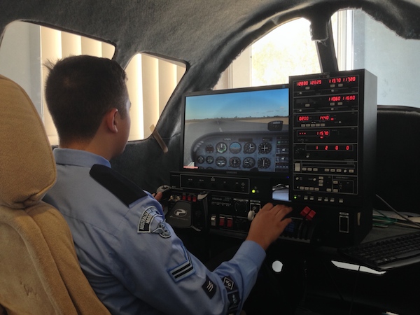 A cadet practises on the flight simulator